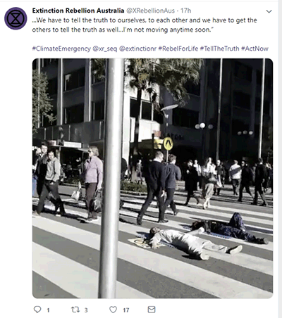 Protestor glued to road